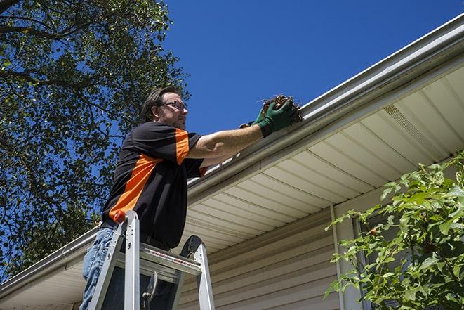 a repairman working on a broken gutter system in Christmas